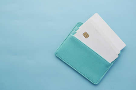 close up of credit cards in a wallet on light green backgroundの写真素材