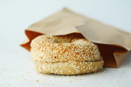fresh bagel bread in a paper on table