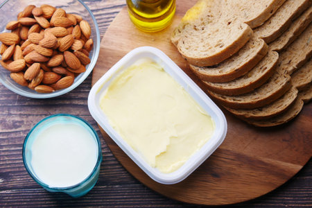 butter , milk, bread and almond nut on tableの写真素材