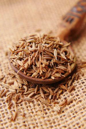 cumin seeds on spoon on table , close upの写真素材