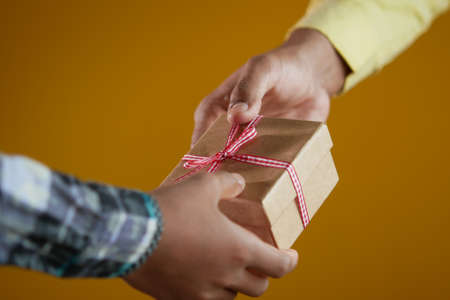 men hand giving homemade gift boxの写真素材