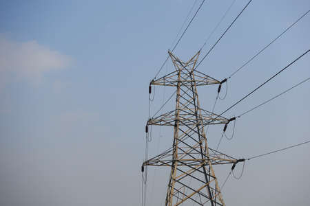 Electric lines against blue sky with copy spaceの写真素材