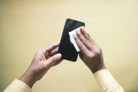 cleaning mobile phone display for preventing virusの写真素材