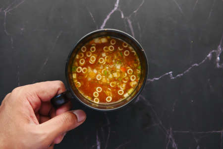 instant cup soup in a mug on tableの写真素材