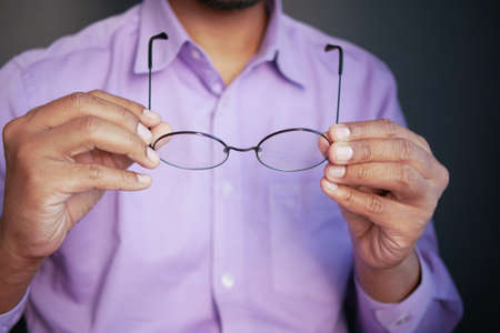 Close up of man hand holding old eyeglassの写真素材