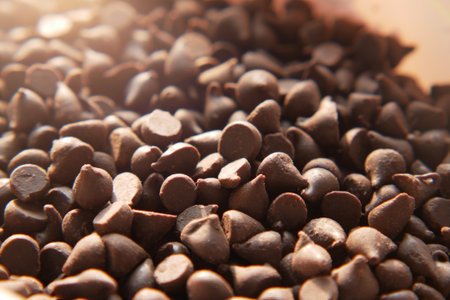 Chocolate chips spilling from a plastic packet,の写真素材