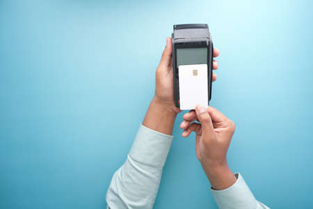contactless payment concept with young man paying with credit cardの写真素材