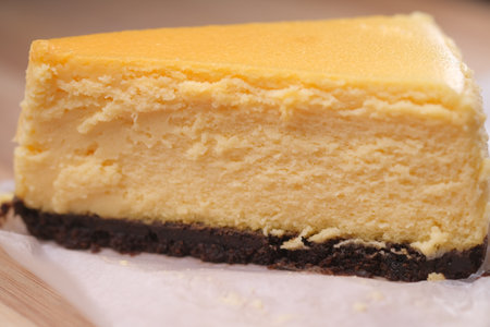 cheese chocolate and cream cake on a plate on tableの写真素材