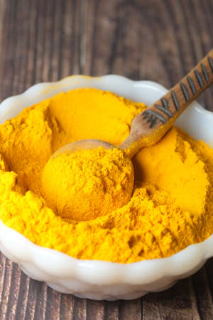 turmeric ginger powder in a in bowl on table ,の写真素材
