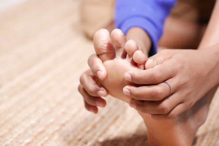 Close up on young man suffering feet painの写真素材