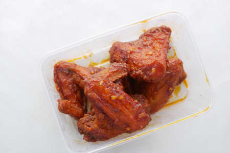 chicken wings in a plastic take away containerの写真素材