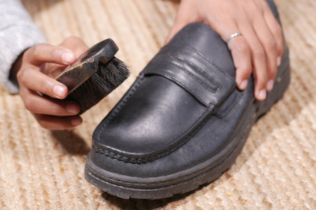 cleaning Shoe with a brush on floorの写真素材