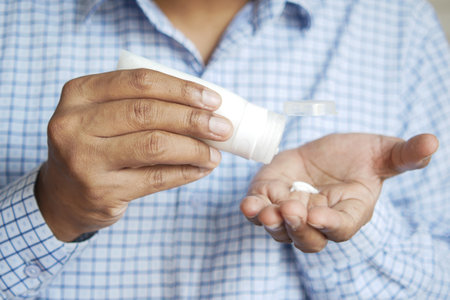 man applying beauty cream onto skinの写真素材