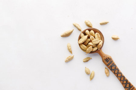 close up of Cardamom on a spoon on tableの写真素材