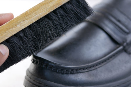 cleaning Shoe with a brush on floor