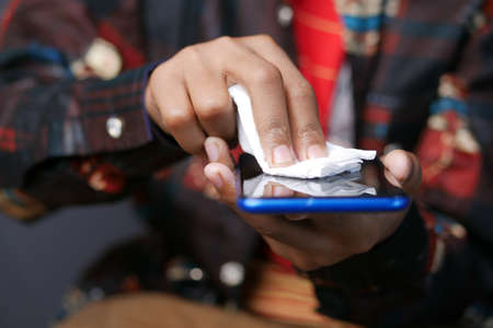 cleaning mobile phone display for preventing virusの写真素材