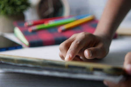 child hand pointing finger on digital tablet screen.の写真素材