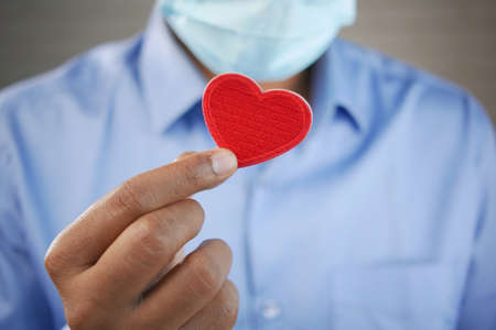 Red heart in hands, donate or charity conceptの写真素材