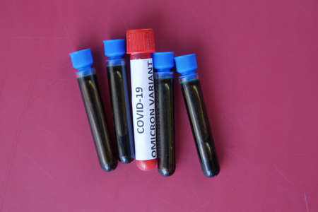 omicron variant corona virus blood test tube on red backgroundの写真素材