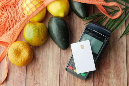 contactless payment concept with young man paying with credit cardの写真素材