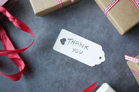 thank you note and gift box on black backgroundの写真素材