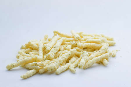 Bowl with tasty potato chips spilling on white backgroundの写真素材