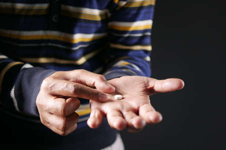 Close up of man hand holding pills with copy spaceの写真素材