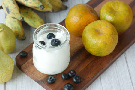 close up of fresh yogurt with blue berry in a bowlの写真素材