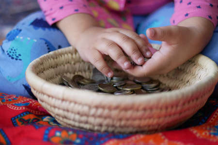 child girl pile coin for saving. sitting on floorの写真素材