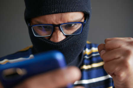 hacker hand stealing data from smart phoneの写真素材