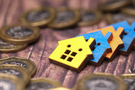 stack of coins and house on table , the concept of house financeの写真素材