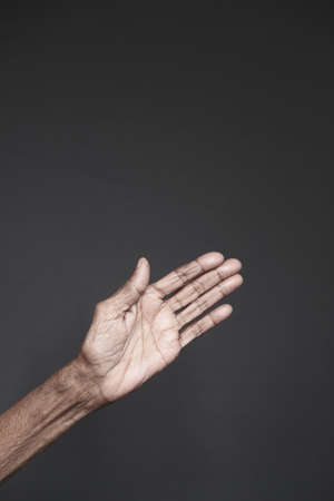 close up of hand of a elderly person isolated on blackの写真素材