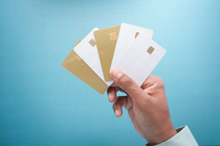 close up of person hand holding many credit cardsの写真素材