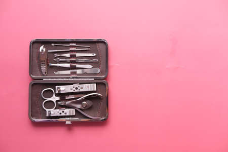 nail cutters for a manicure on red backgroundの写真素材