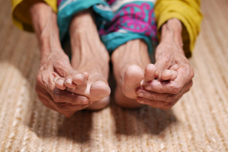 Close up on senior women feet and hand massage on injury spot.の写真素材