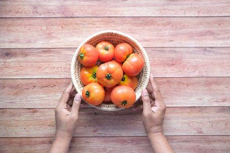 Hand Of Person Picking Tomatoes from a Bowl