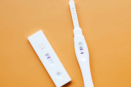 Pregnancy test kit on orange backgroundの写真素材