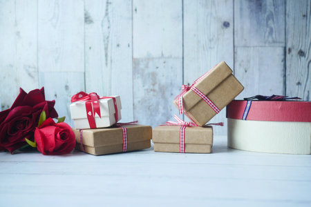 Homemade gift box on table and rose flower on table with copy space