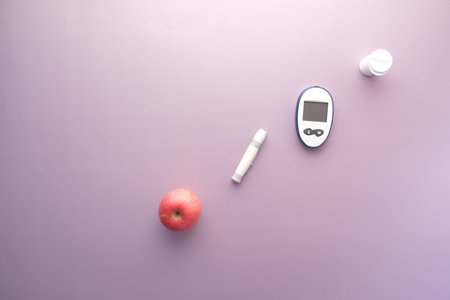 diabetic measurement tools, apple on purple background