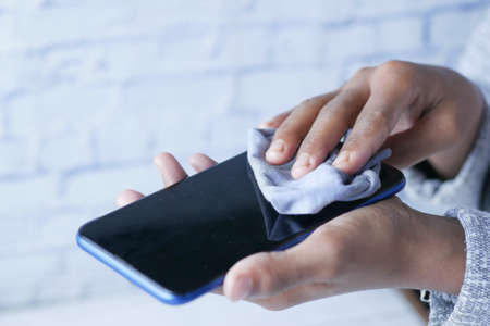 cleaning mobile phone display for preventing virusの写真素材