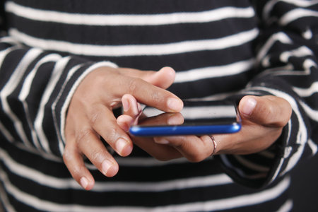 child hand pointing finger on smart phone screen.の写真素材