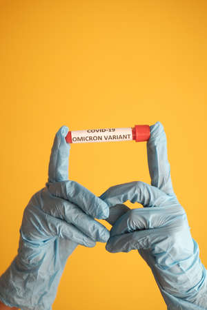 hand hold omicron variant corona virus blood test tubeの写真素材