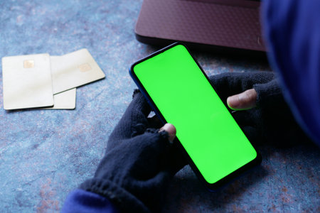 hacker hand stealing data from smart phoneの写真素材