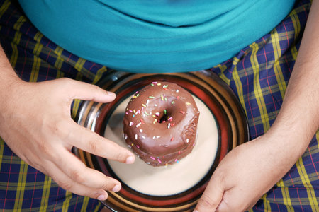 young man eating donut , selective focusの写真素材