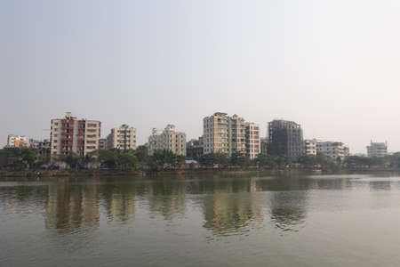 financial and residential buildings in dhaka city in bangladesh on river sideの写真素材