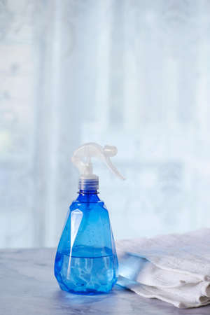cleaning towel and bottle on table at homeの写真素材