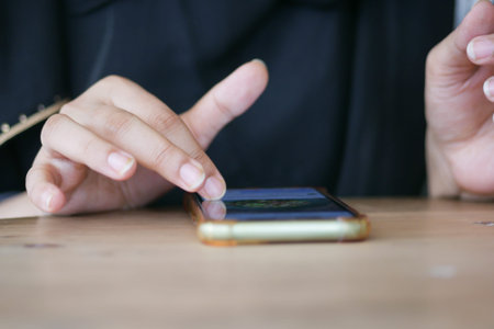 close up of women hand holding smart phone