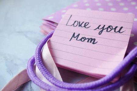 mother day concept with sticky notepad with text and gift box on tableの写真素材