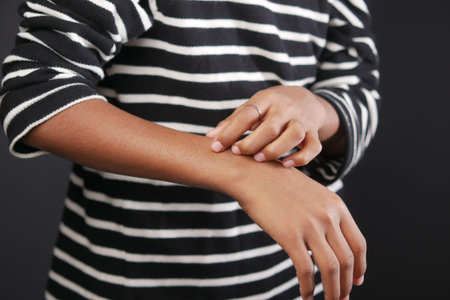 man suffering from itching skin, close up.