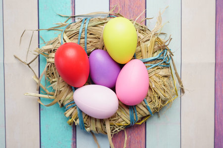 easter concept with multi color egg on pink background.